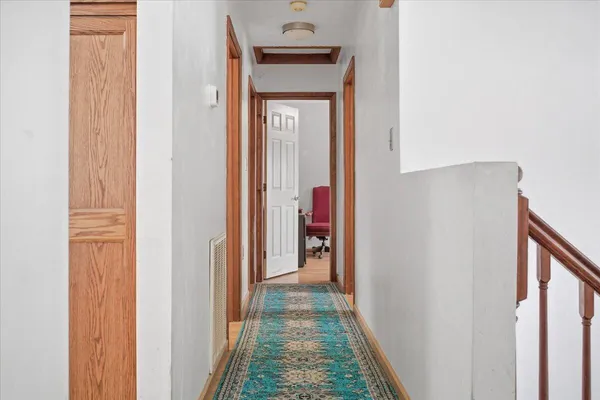 a view of a hallway with wooden floor and a hallway