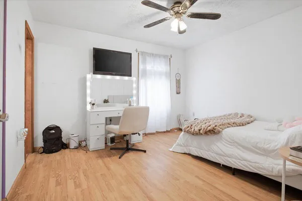 a bedroom with a bed and a chandelier