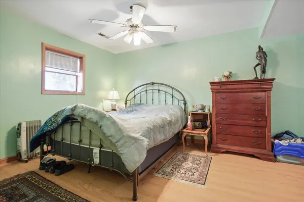 a bedroom with a bed and a chandelier