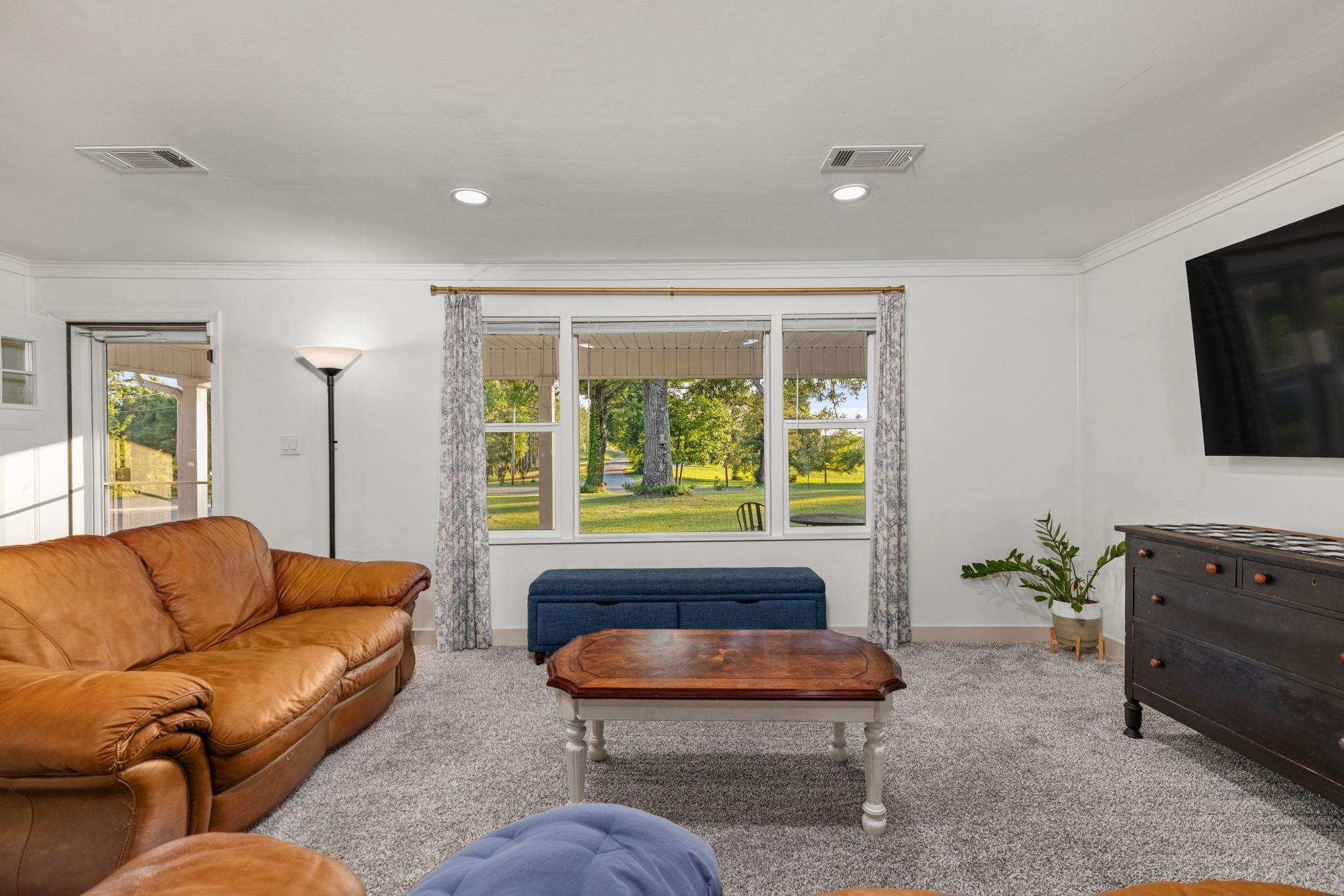 66 County Road 511 Corinth, MS 38834 - Photo 7 of 40 Living area featuring a large picture window, recessed lighting, crown molding, and plush carpeting