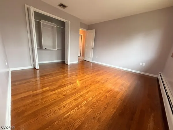 an empty room with wooden floor and door