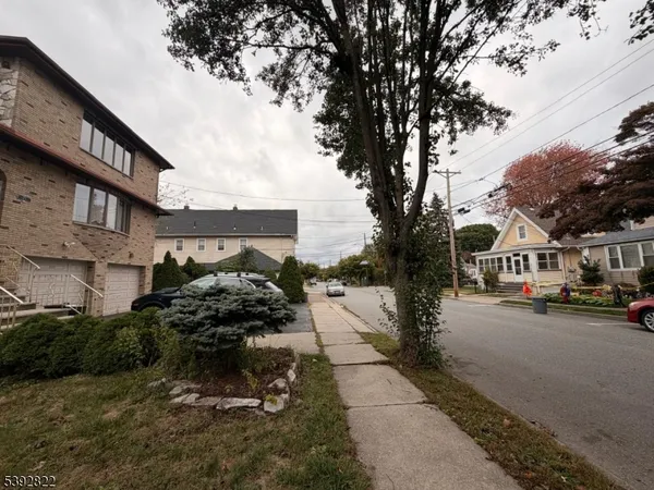 a view of a street with houses on both side