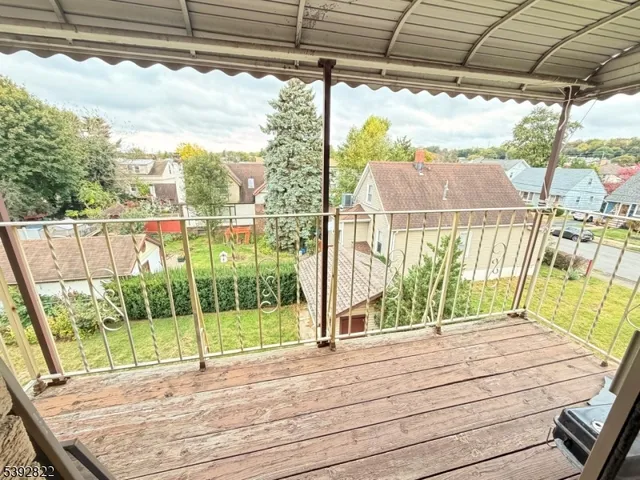 a view of a balcony with yard