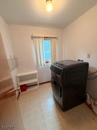 a living room with a bed furniture and a window