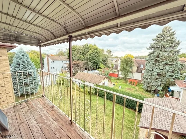 a view of a balcony with wooden floor