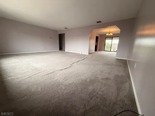 a view of a room with window and chandelier