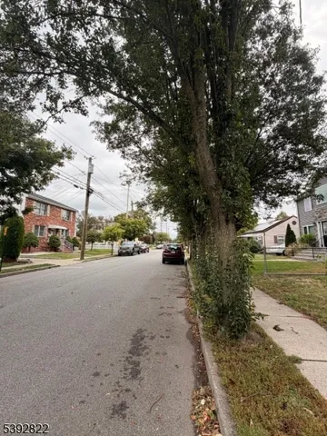a city view with tall buildings and a yard