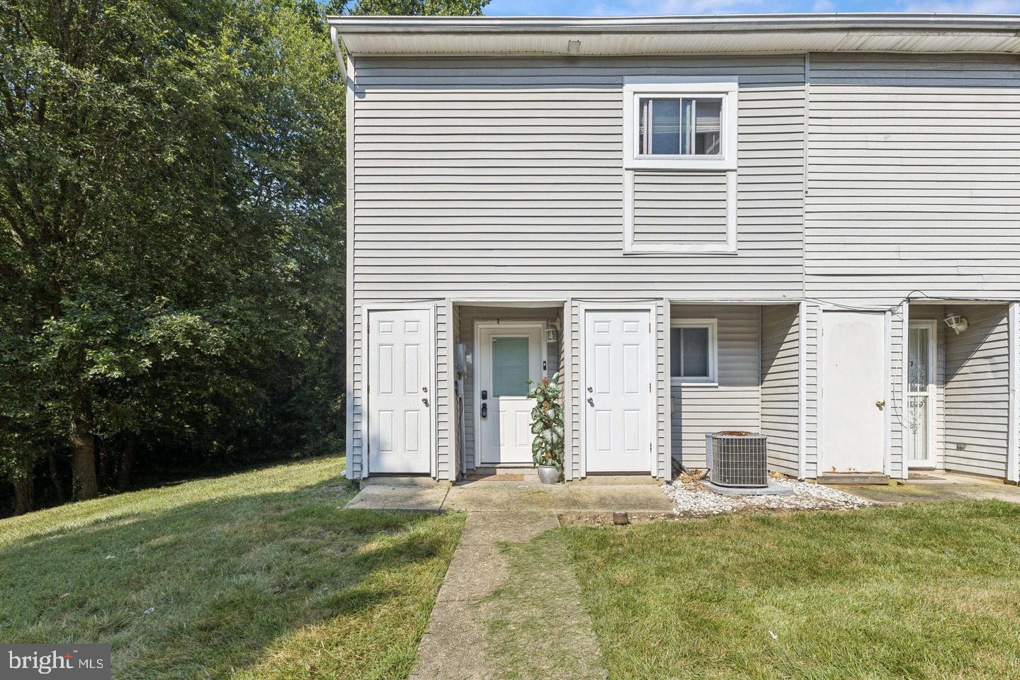 3059 Heath Cote Road Waldorf, MD 20602 - Photo 15 of 15 a view of a white house with a yard and large tree