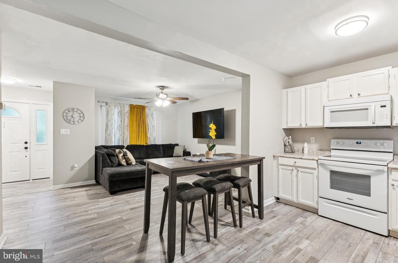 3059 Heath Cote Road Waldorf, MD 20602 - Photo 6 of 15 a view of a kitchen area with furniture and wooden floor
