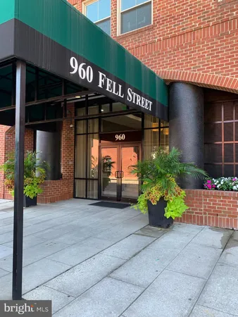 a view of a street with potted plants