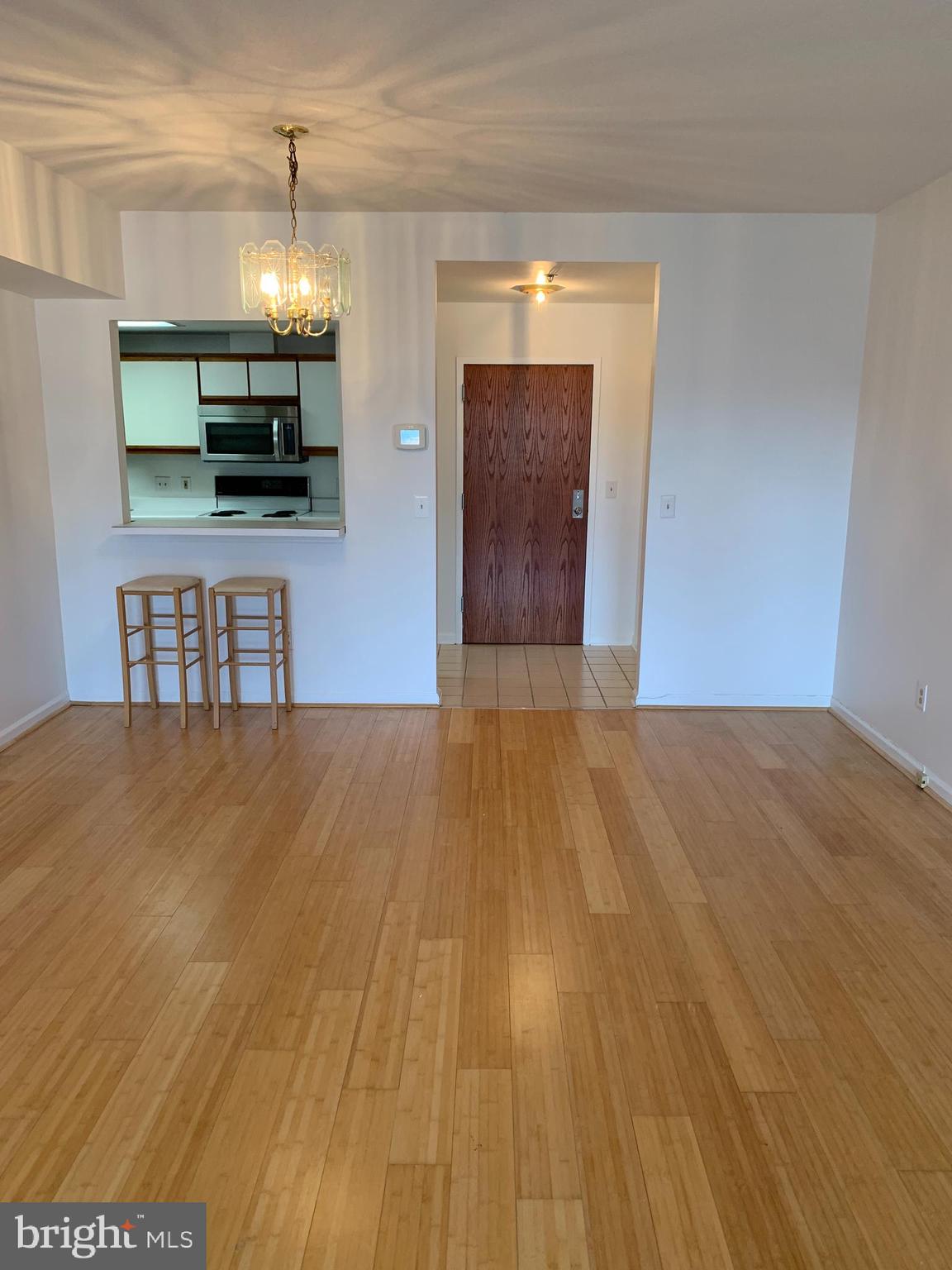 960 Fell Street, Unit 504 Baltimore, MD 21231 - Photo 17 of 32 a view of empty room with wooden floor and fireplace