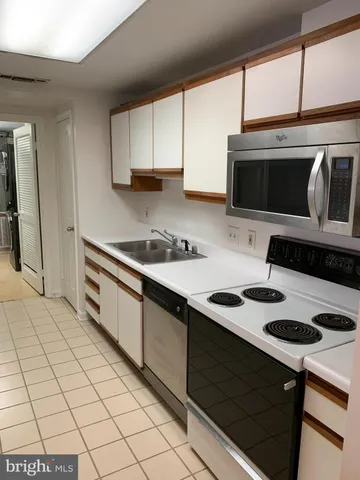 a kitchen with a sink and a stove top oven