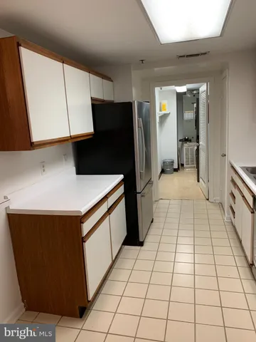 a kitchen with stainless steel appliances a sink a counter top space and cabinets