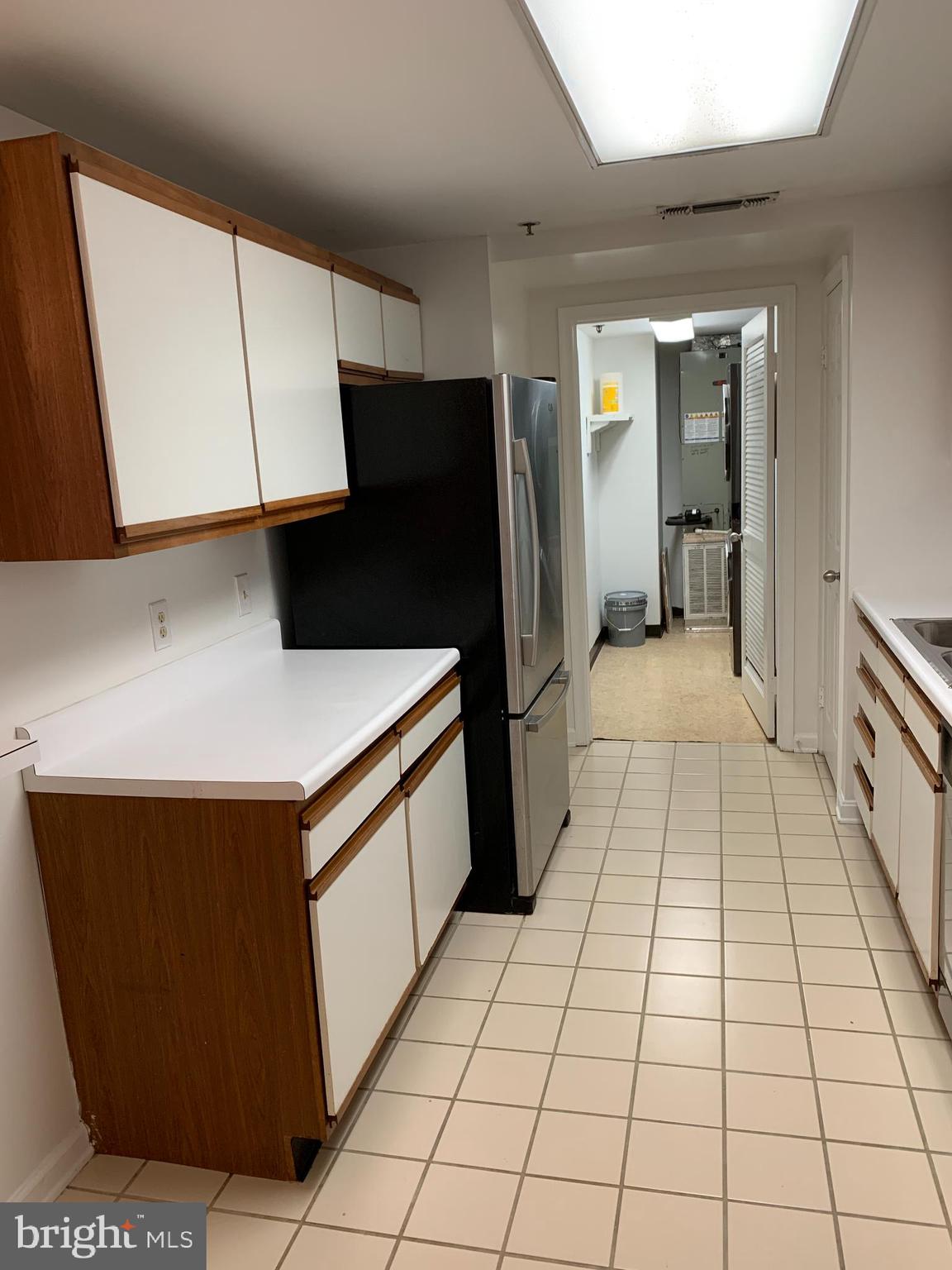 960 Fell Street, Unit 504 Baltimore, MD 21231 - Photo 19 of 32 a kitchen with stainless steel appliances a sink a counter top space and cabinets