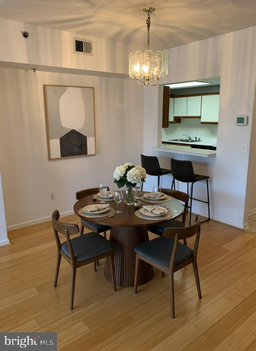 960 Fell Street, Unit 504 Baltimore, MD 21231 - Photo 7 of 32 a view of a dining room with furniture and chandelier