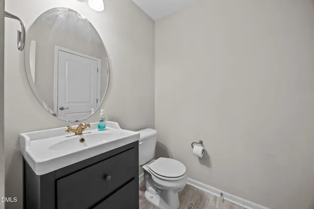 a bathroom with a sink toilet and mirror