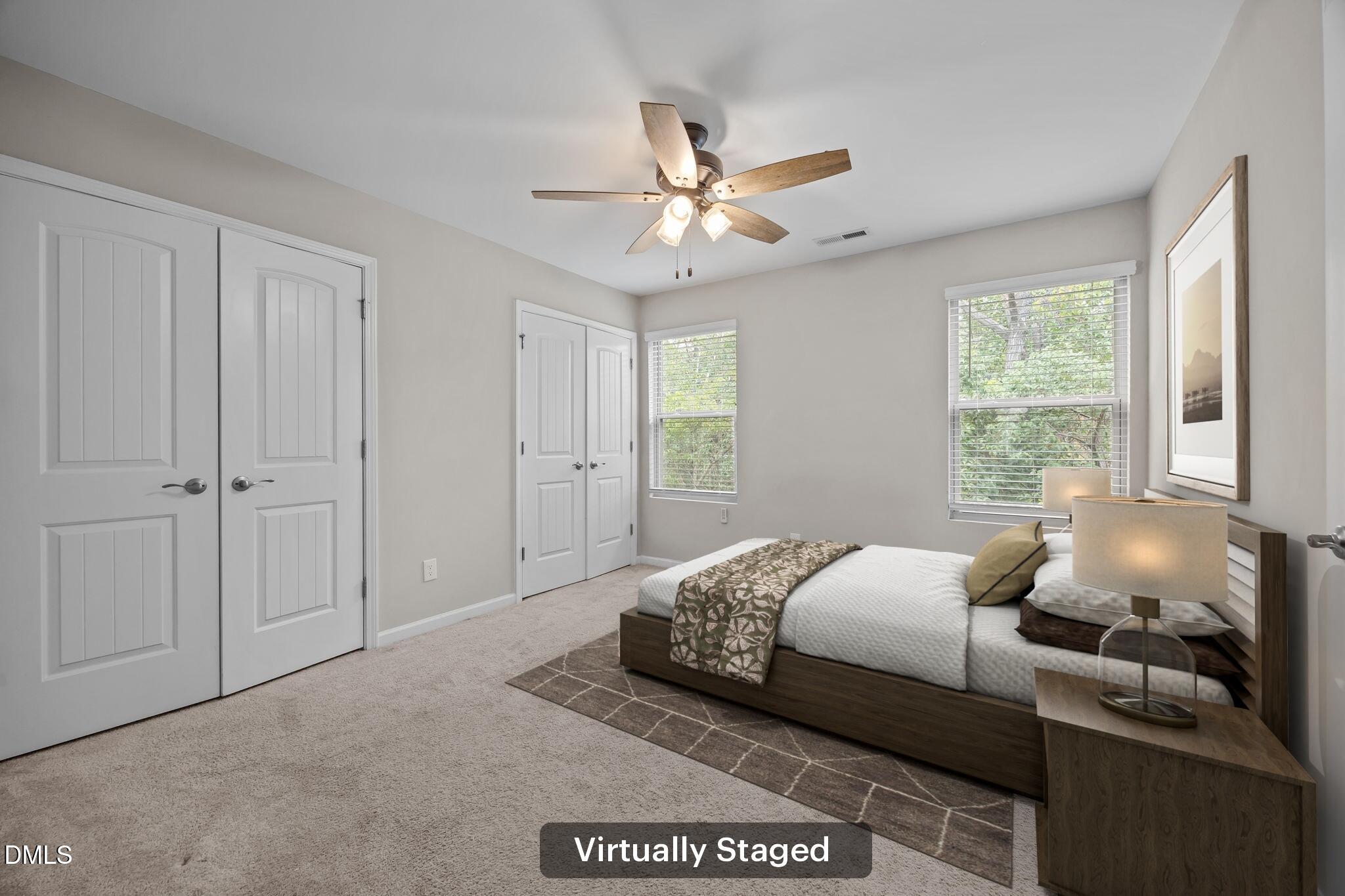 221 Socket Street Raleigh, NC 27606 - Photo 13 of 28 a bedroom with a bed and a chandelier