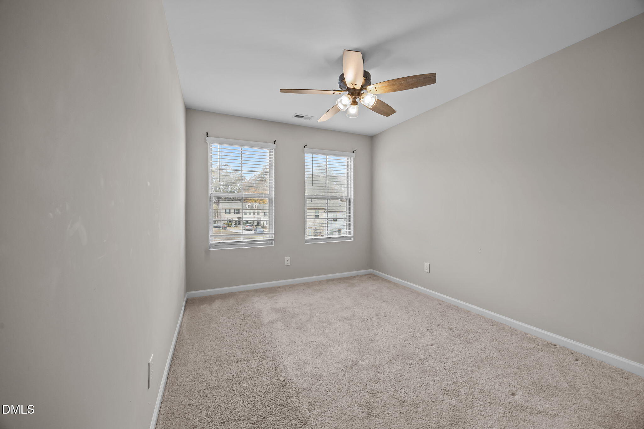 221 Socket Street Raleigh, NC 27606 - Photo 19 of 28 an empty room with windows and fan