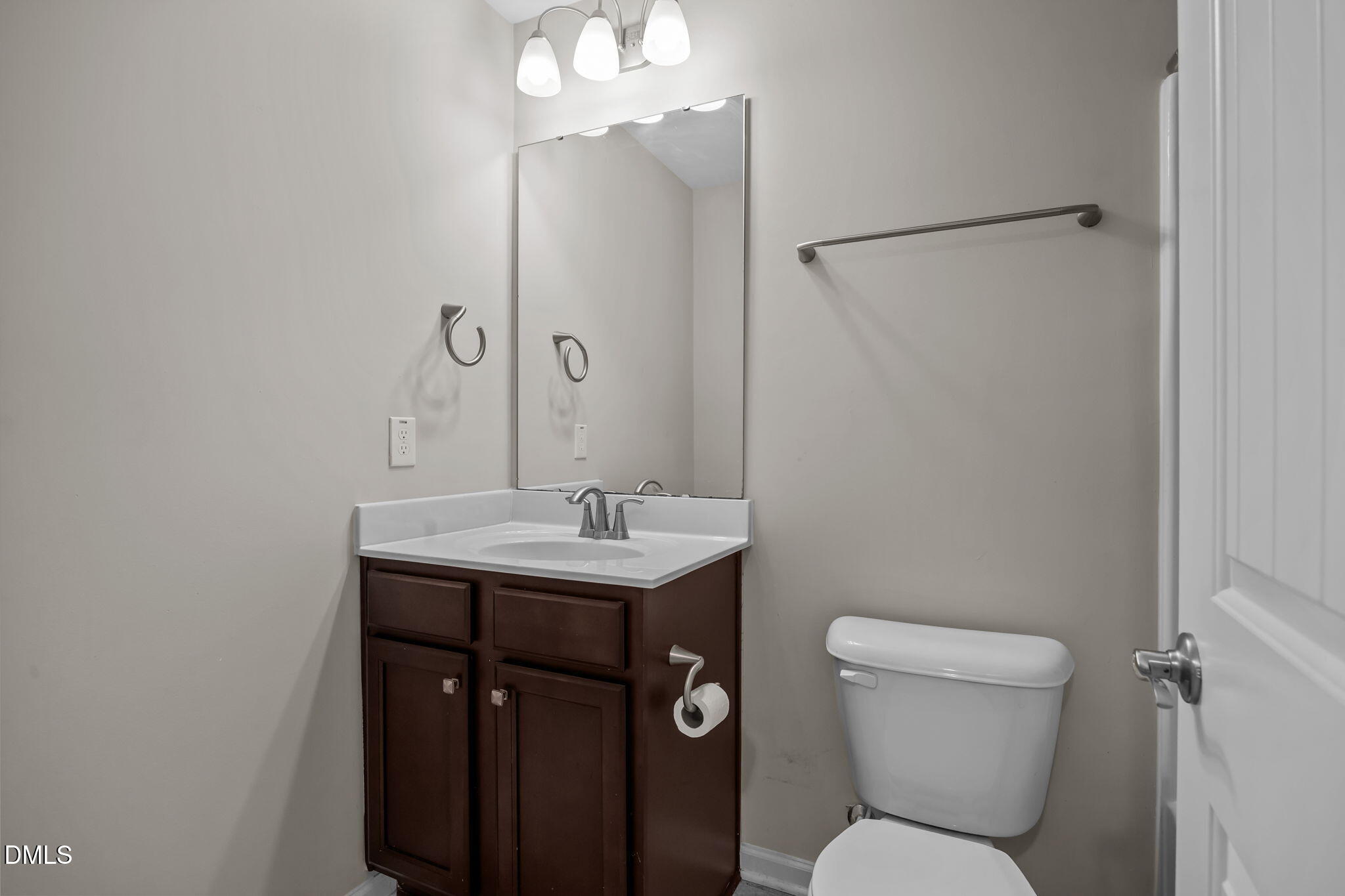 221 Socket Street Raleigh, NC 27606 - Photo 21 of 28 a bathroom with a toilet sink and mirror