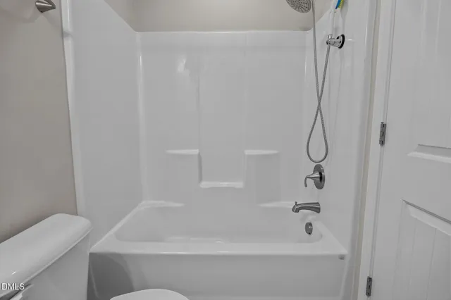 a bathroom with a tub and a shower