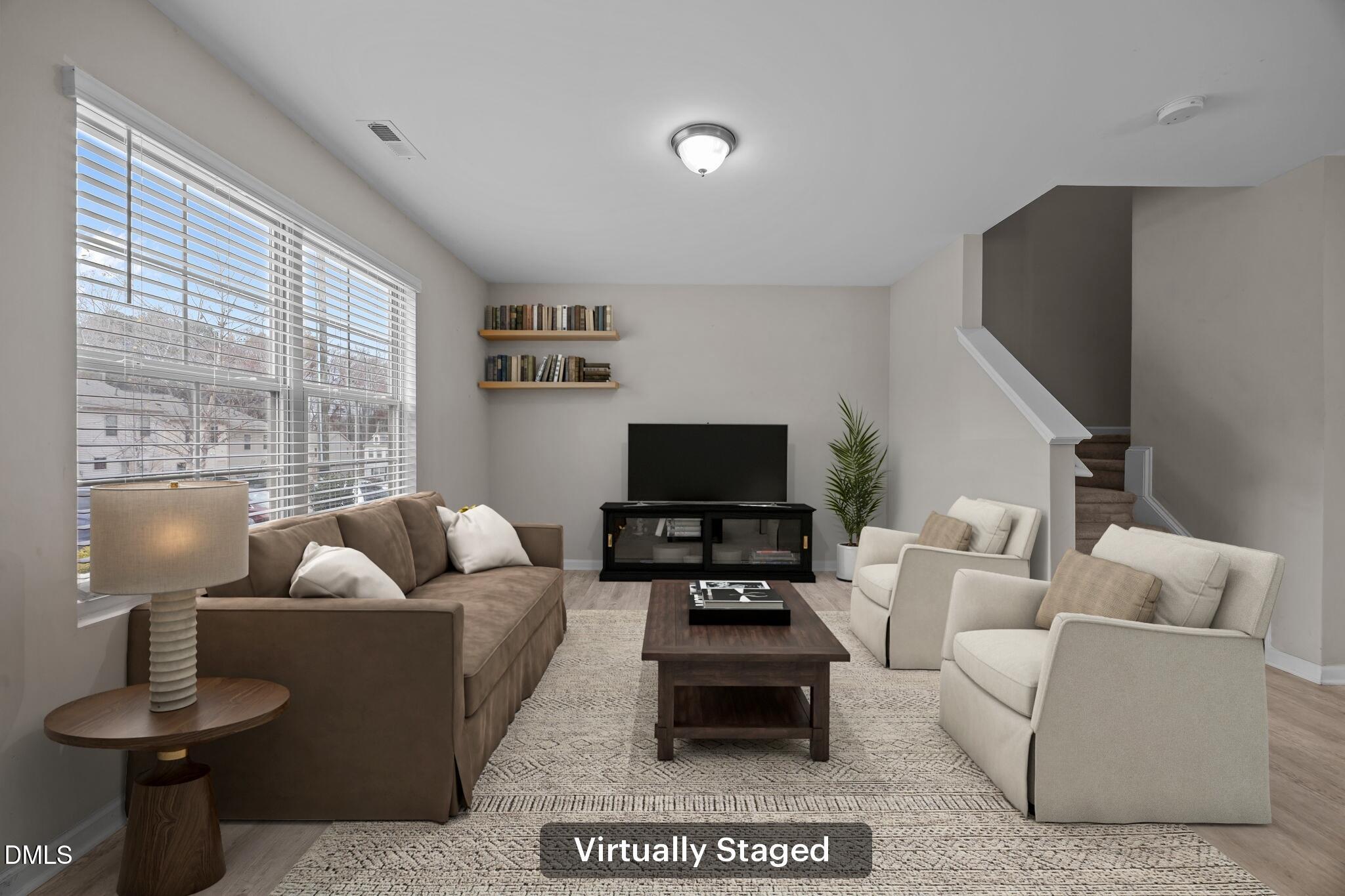 221 Socket Street Raleigh, NC 27606 - Photo 3 of 28 a living room with furniture a flat screen tv and a large window
