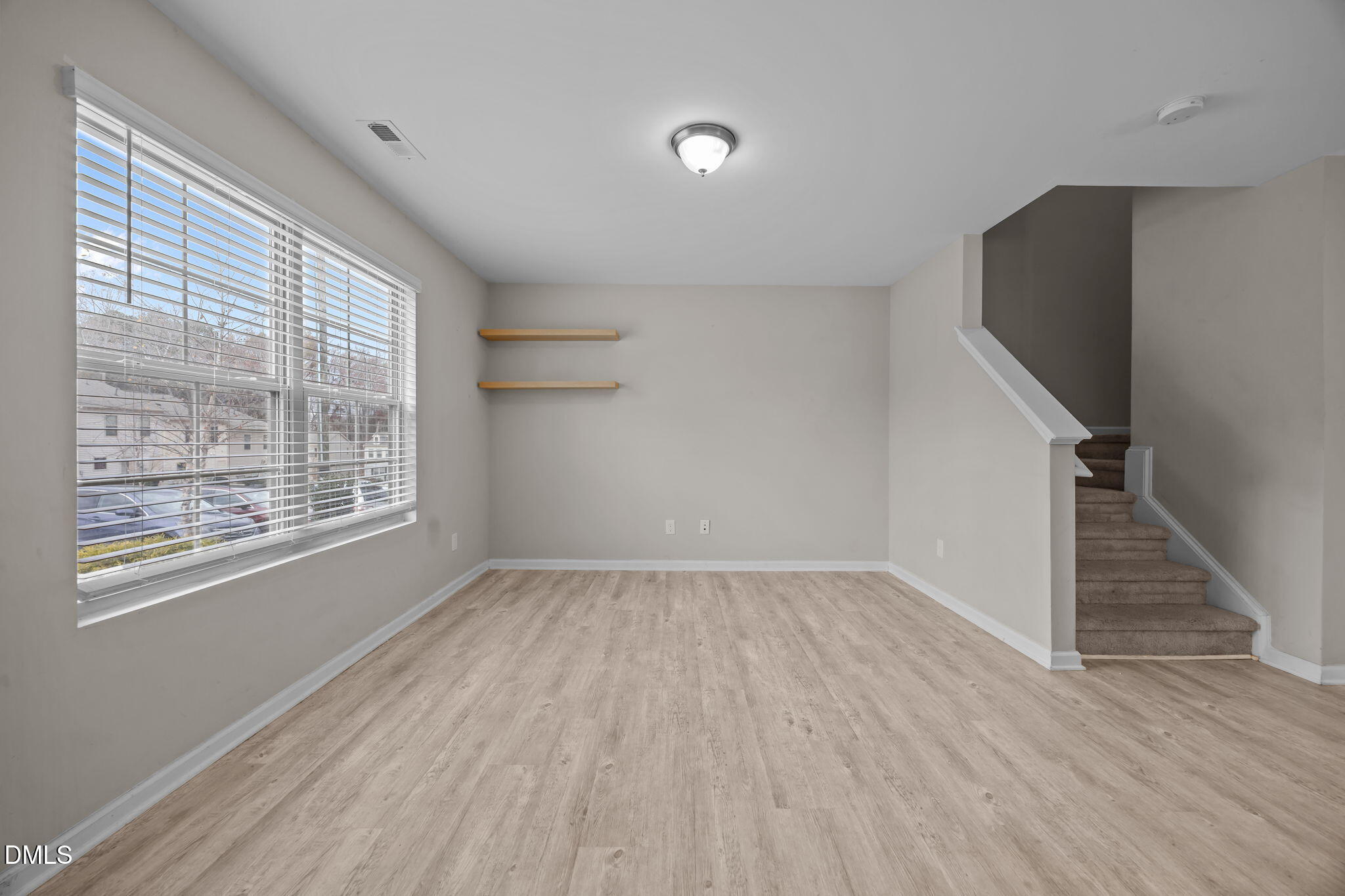221 Socket Street Raleigh, NC 27606 - Photo 4 of 28 a view of an empty room with wooden floor and a window