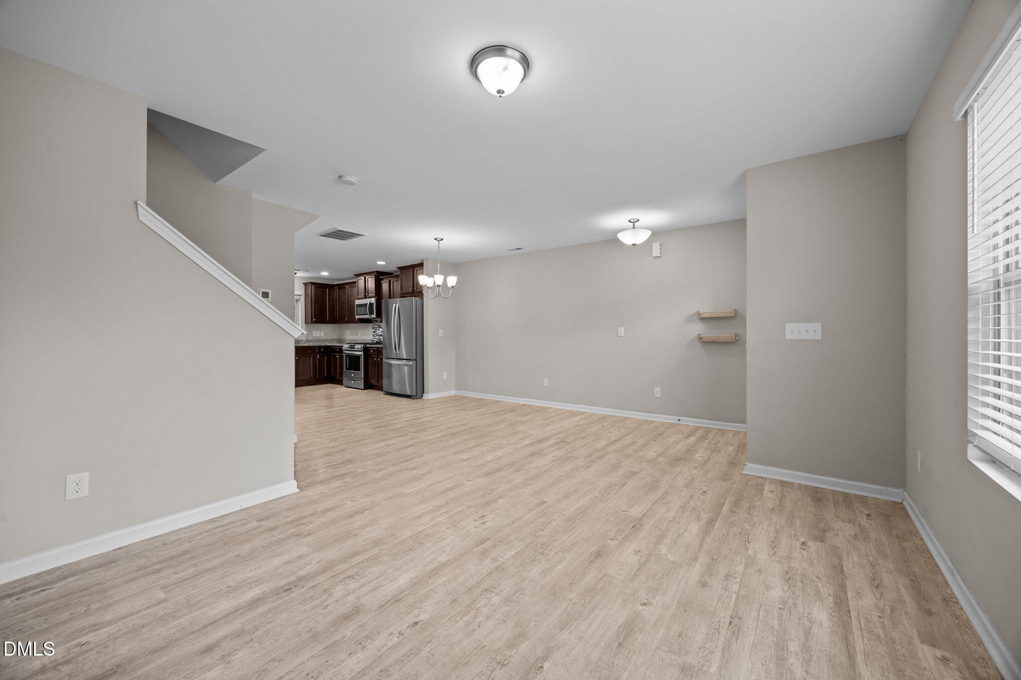 221 Socket Street Raleigh, NC 27606 - Photo 5 of 28 a view of empty room with wooden floor and window