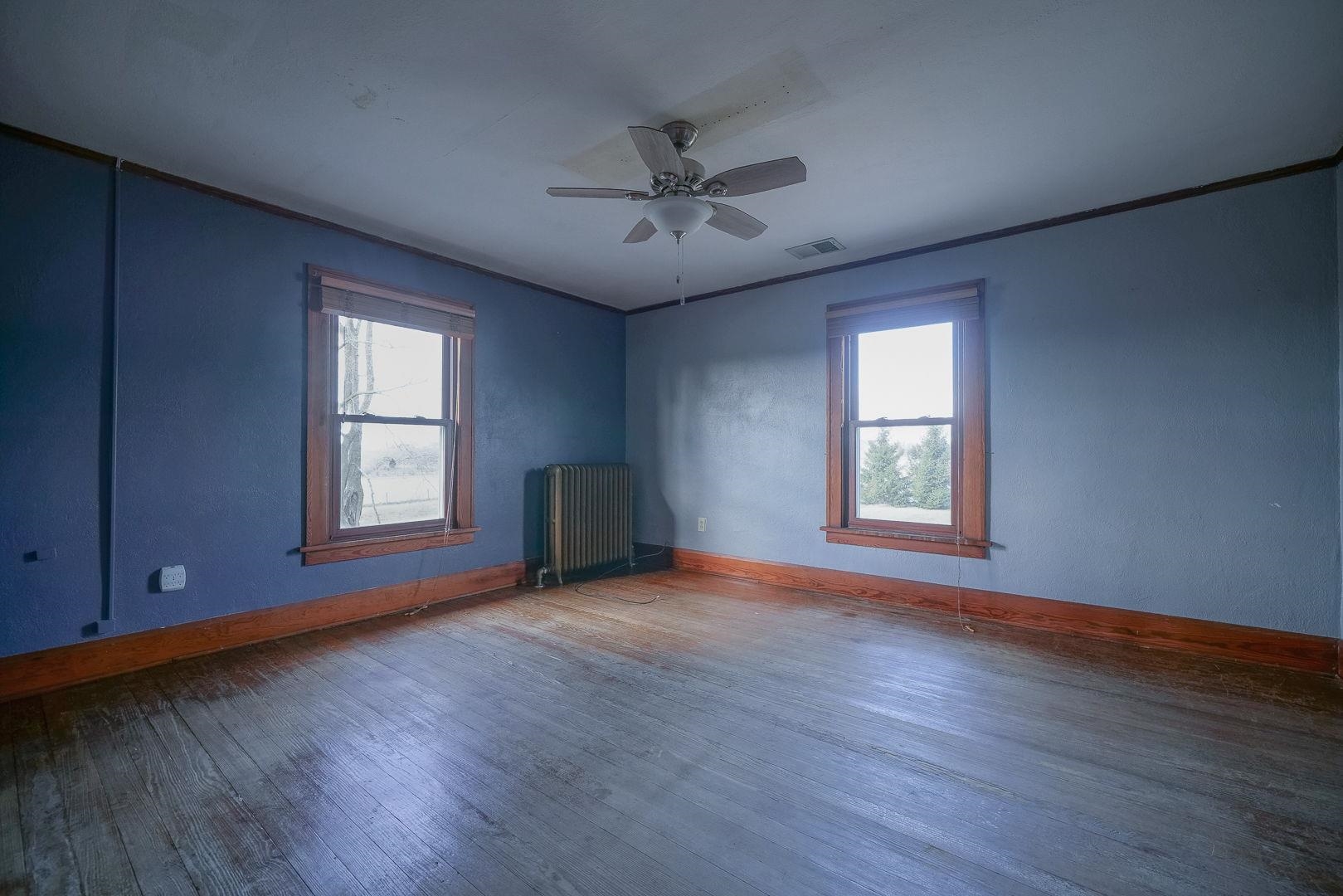 6259 North Pecatonica Road Pecatonica, IL 61063 - Photo 15 of 48 an empty room with wooden floor and windows