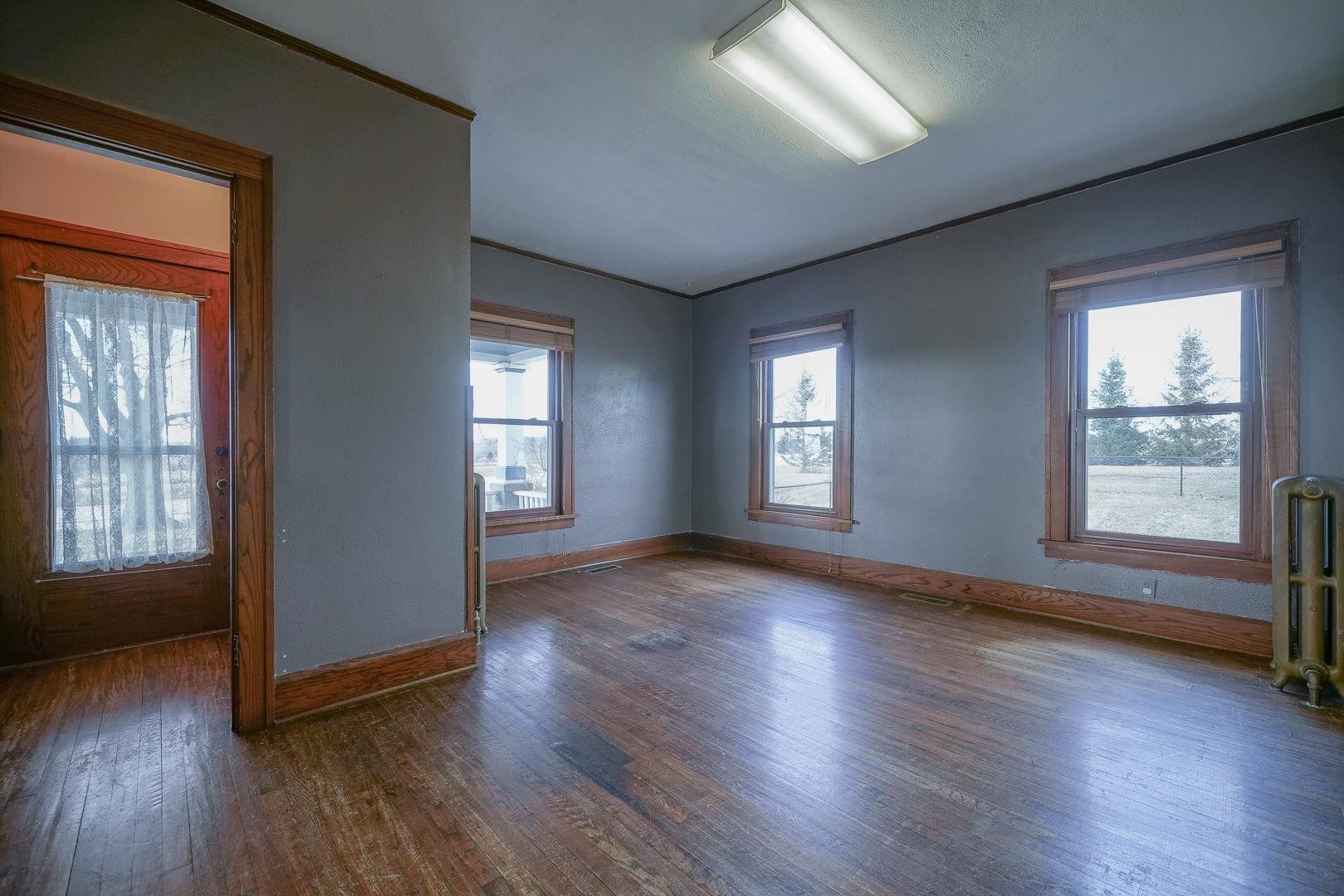 6259 North Pecatonica Road Pecatonica, IL 61063 - Photo 41 of 48 an empty room with wooden floor and windows