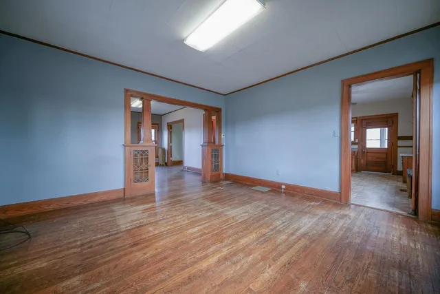 wooden floor in an empty room with a window