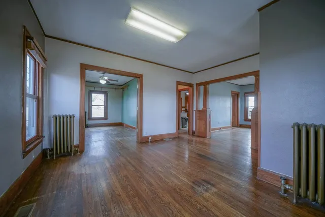 wooden floor with a window in a hall with an entryway
