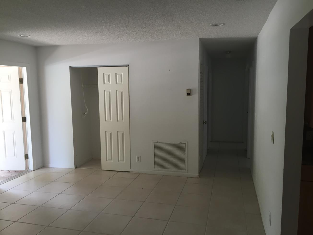 9276 Saddlebrook Drive Boca Raton, FL 33496 - Photo 5 of 10 an empty room with windows and closet