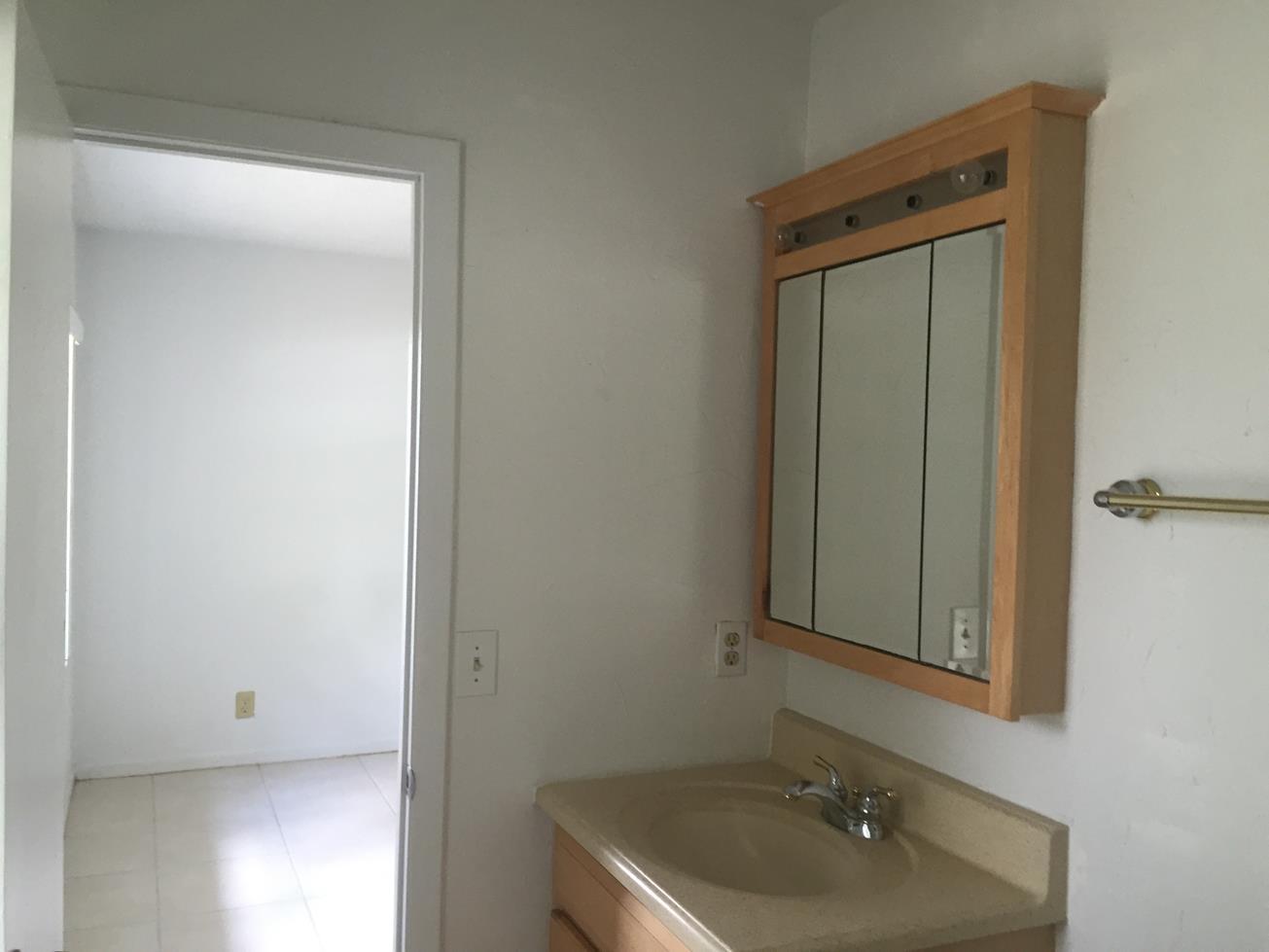 9276 Saddlebrook Drive Boca Raton, FL 33496 - Photo 8 of 10 a bathroom with a sink and a mirror