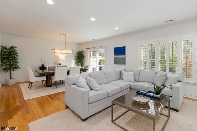 a living room with furniture and a view of kitchen