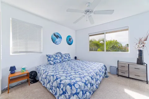 a bedroom with a large bed and a chandelier