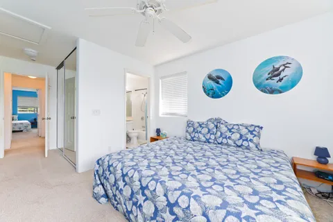 a bedroom with two beds and a lamp