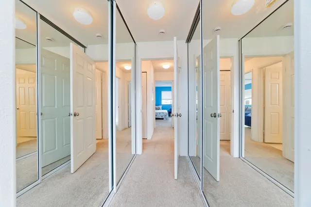 a view of hallway with livingroom and furniture