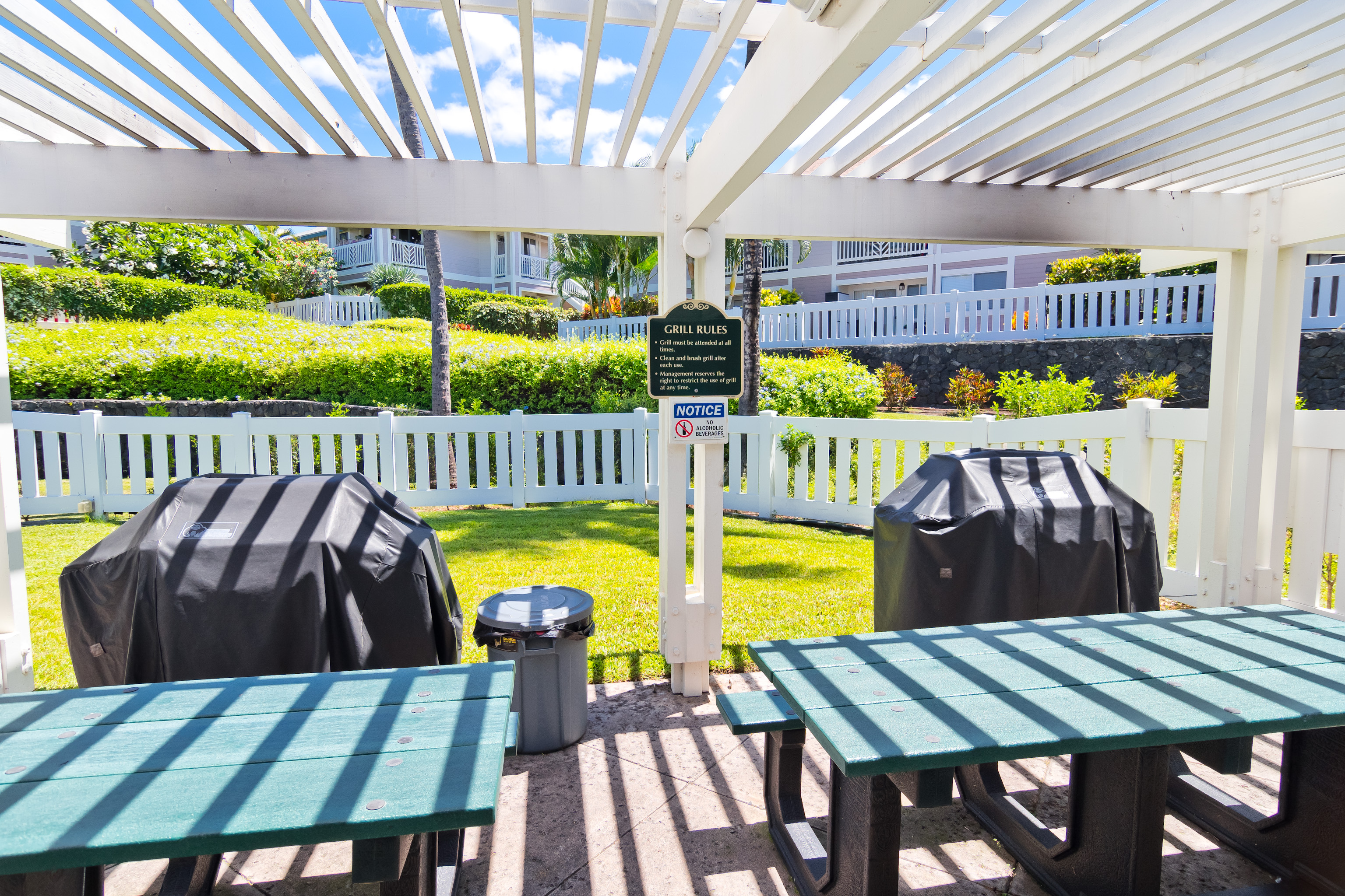 75-6081 Alii Drive, Unit O201 Kailua-Kona, HI 96740 - Photo 25 of 28 a view of an outdoor dining space with a table or chairs