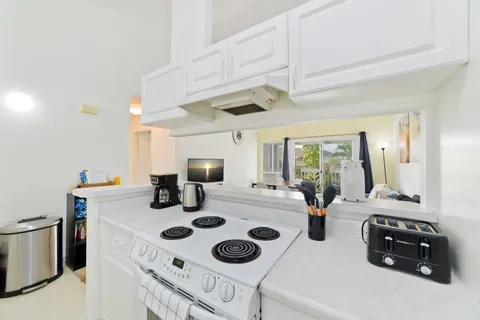 a kitchen with appliances a sink and cabinets