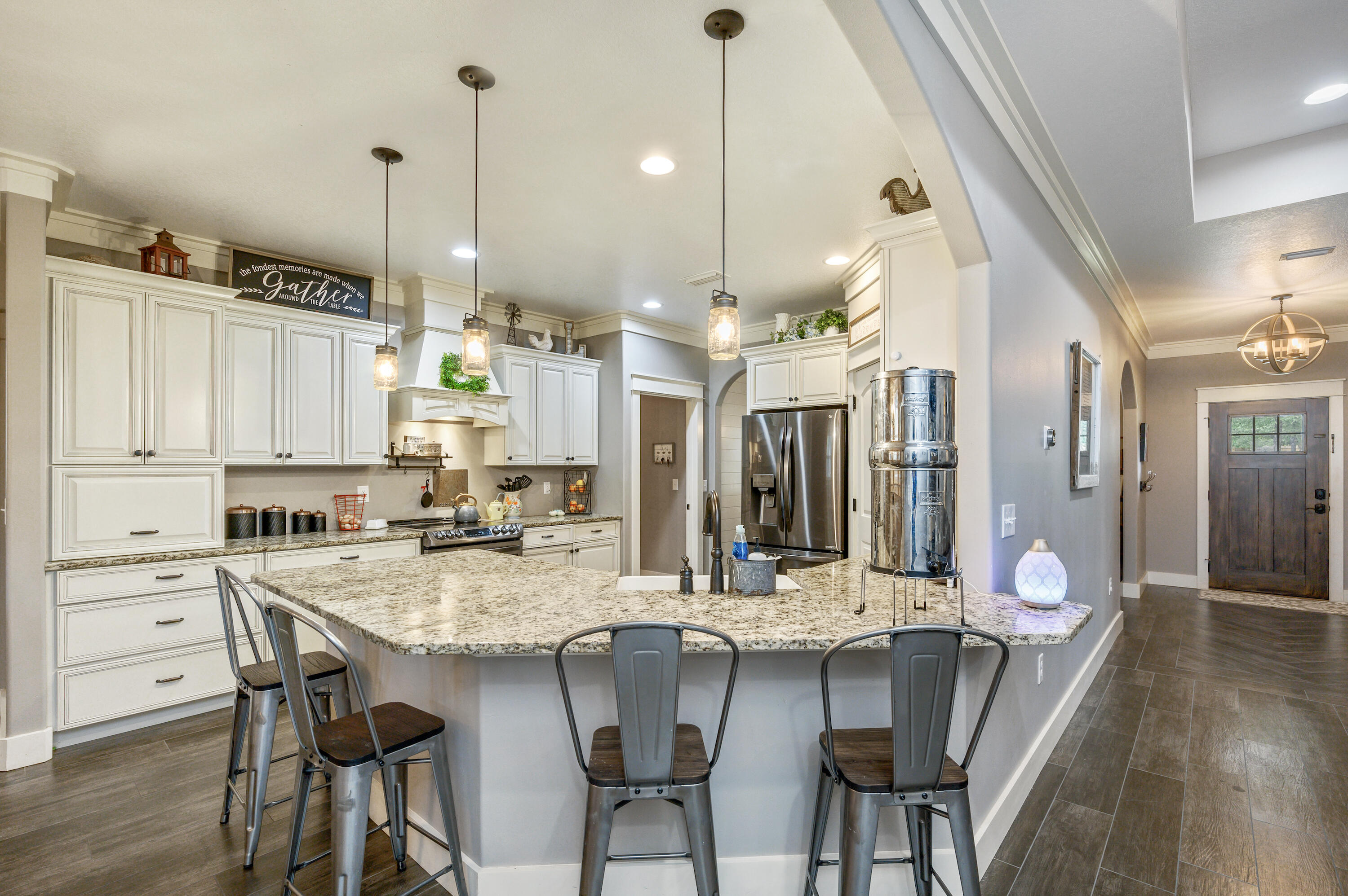 6053 Dairy Road Baker, FL 32531 - Photo 16 of 55 a kitchen with granite countertop a table chairs stove and wooden floor