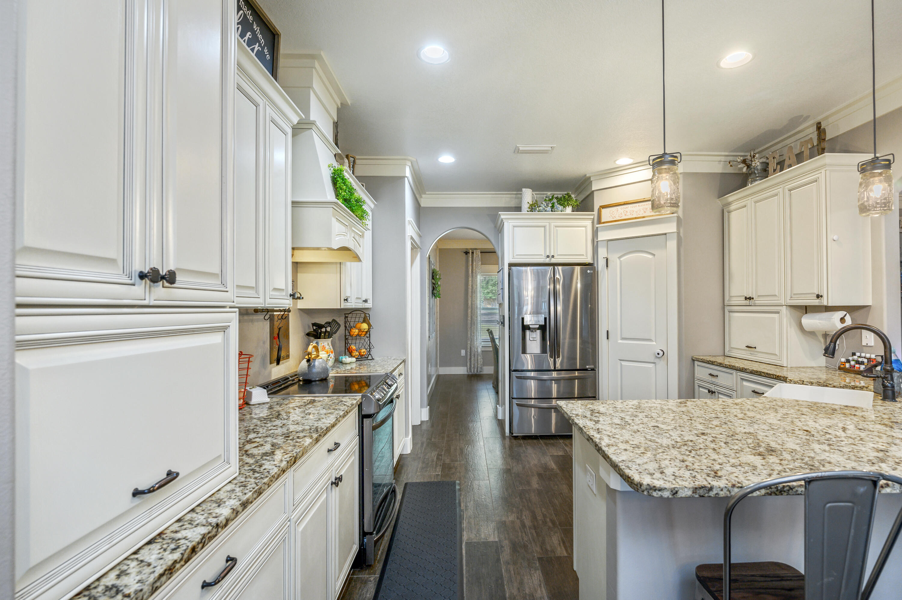 6053 Dairy Road Baker, FL 32531 - Photo 17 of 55 a kitchen with stainless steel appliances granite countertop a kitchen island a stove and a sink