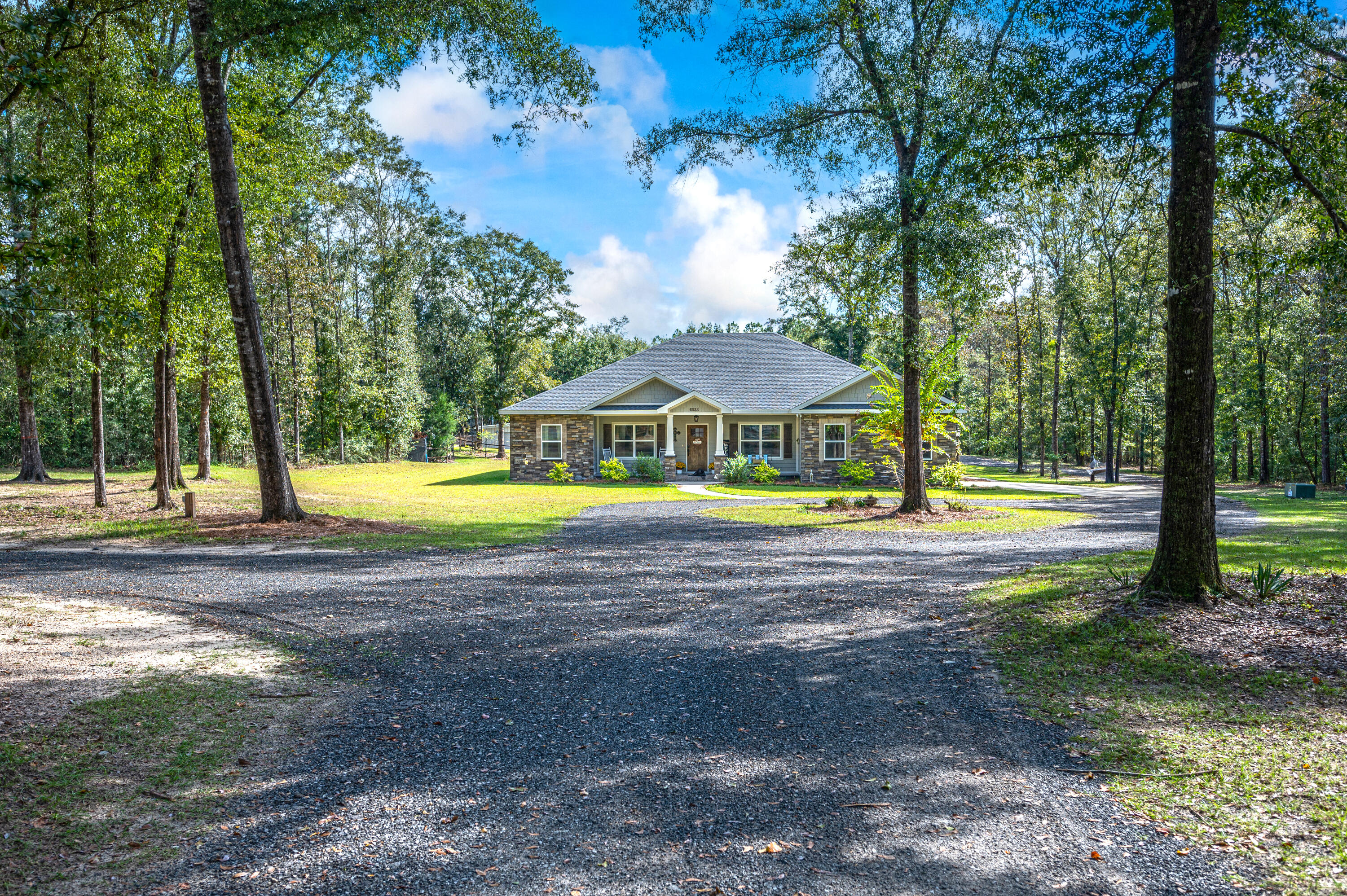 6053 Dairy Road Baker, FL 32531 - Photo 4 of 55 a view of a house with swimming pool and yard