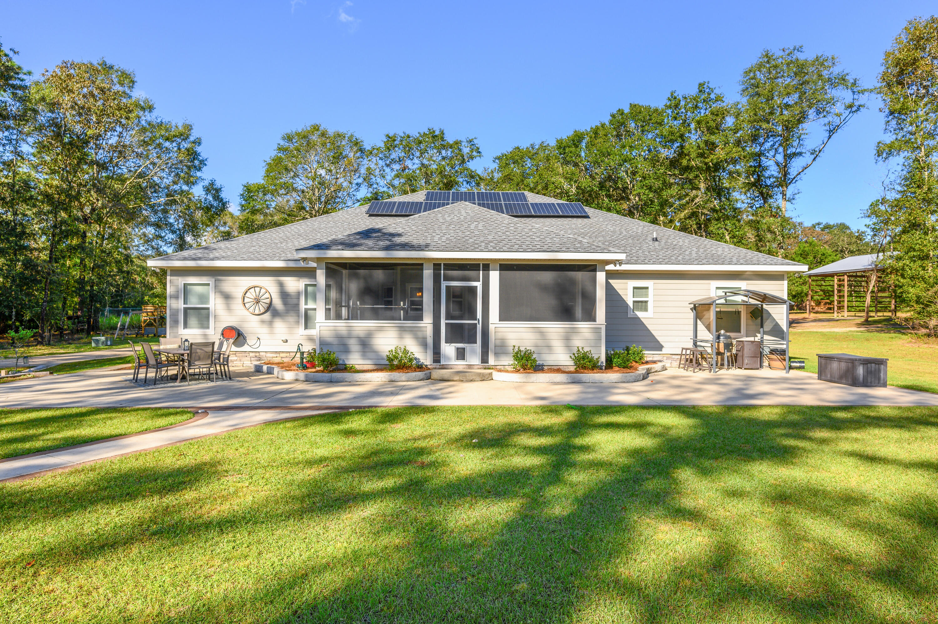 6053 Dairy Road Baker, FL 32531 - Photo 44 of 55 a front view of a house with swimming pool having outdoor seating