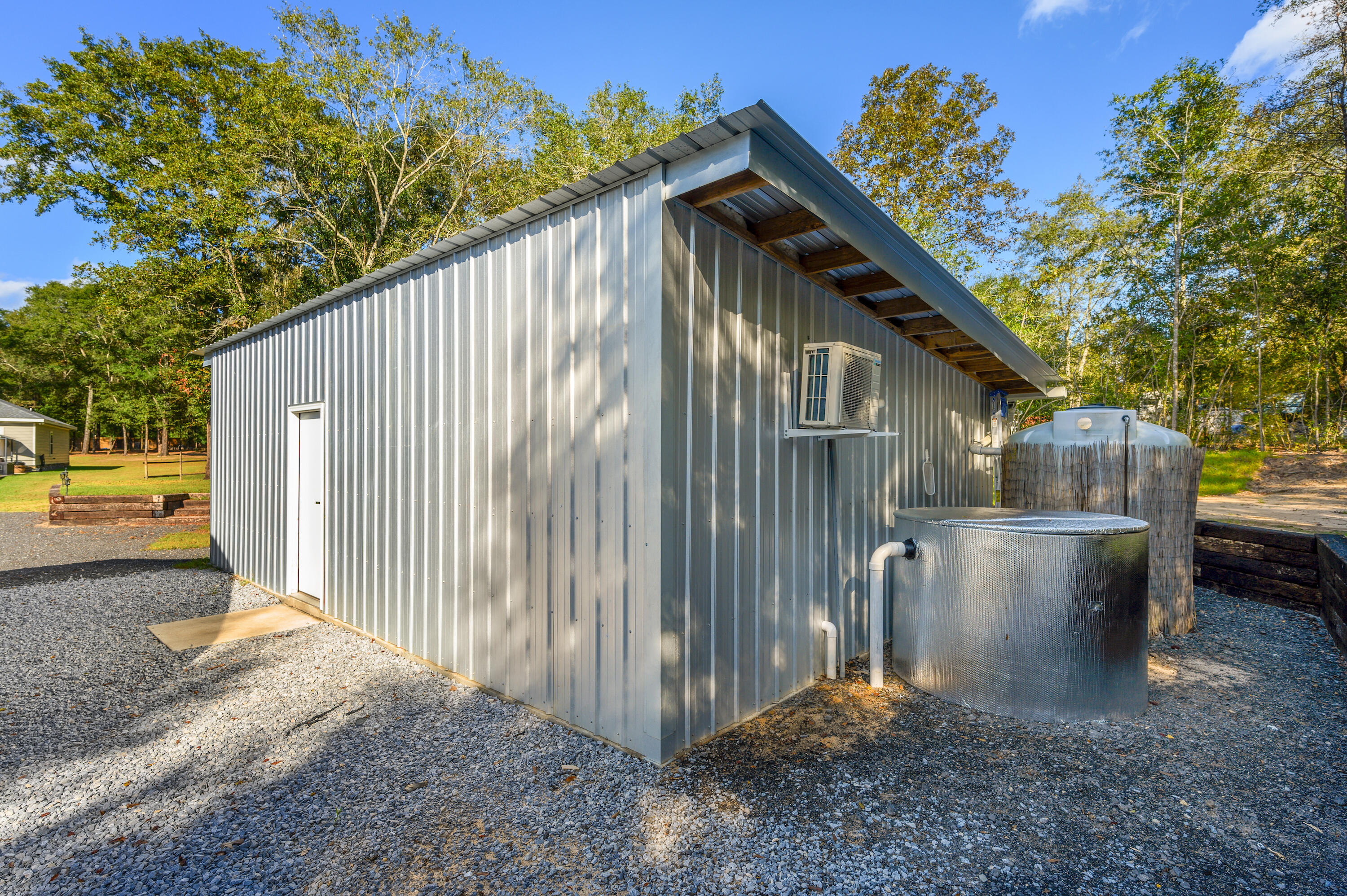 6053 Dairy Road Baker, FL 32531 - Photo 47 of 55 a view of a small house with a small yard and a large tree