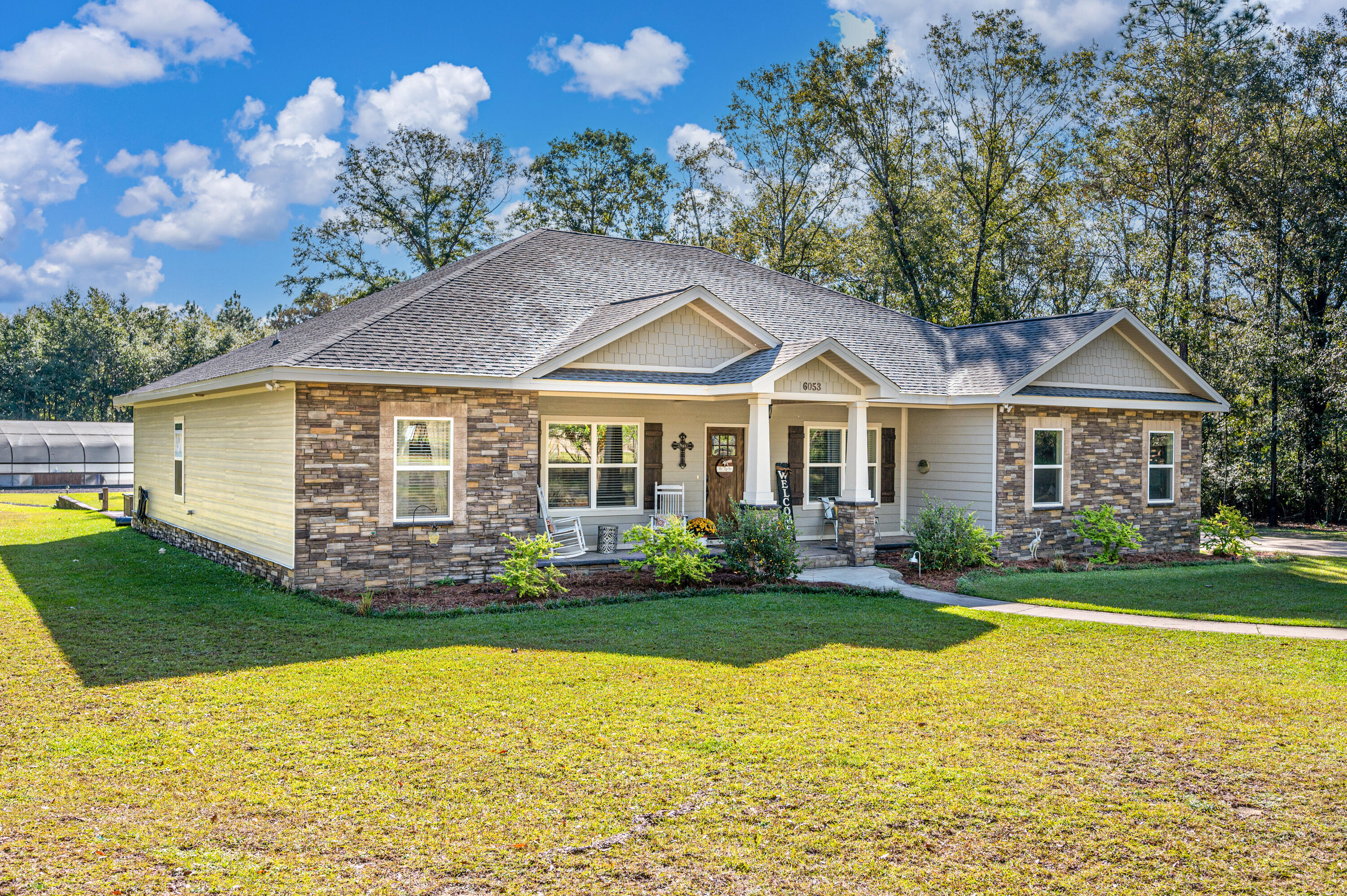 6053 Dairy Road Baker, FL 32531 - Photo 6 of 55 a front view of a house with a yard
