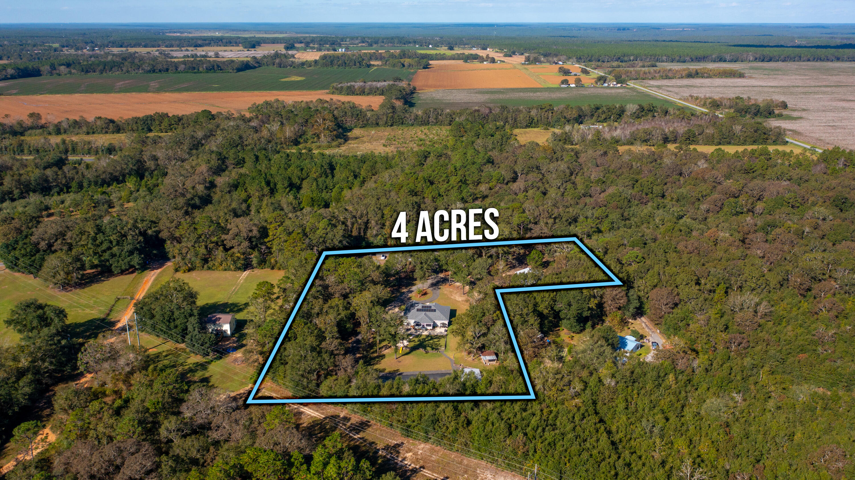 6053 Dairy Road Baker, FL 32531 - Photo 53 of 55 an aerial view of a house with a yard lake view and mountain view