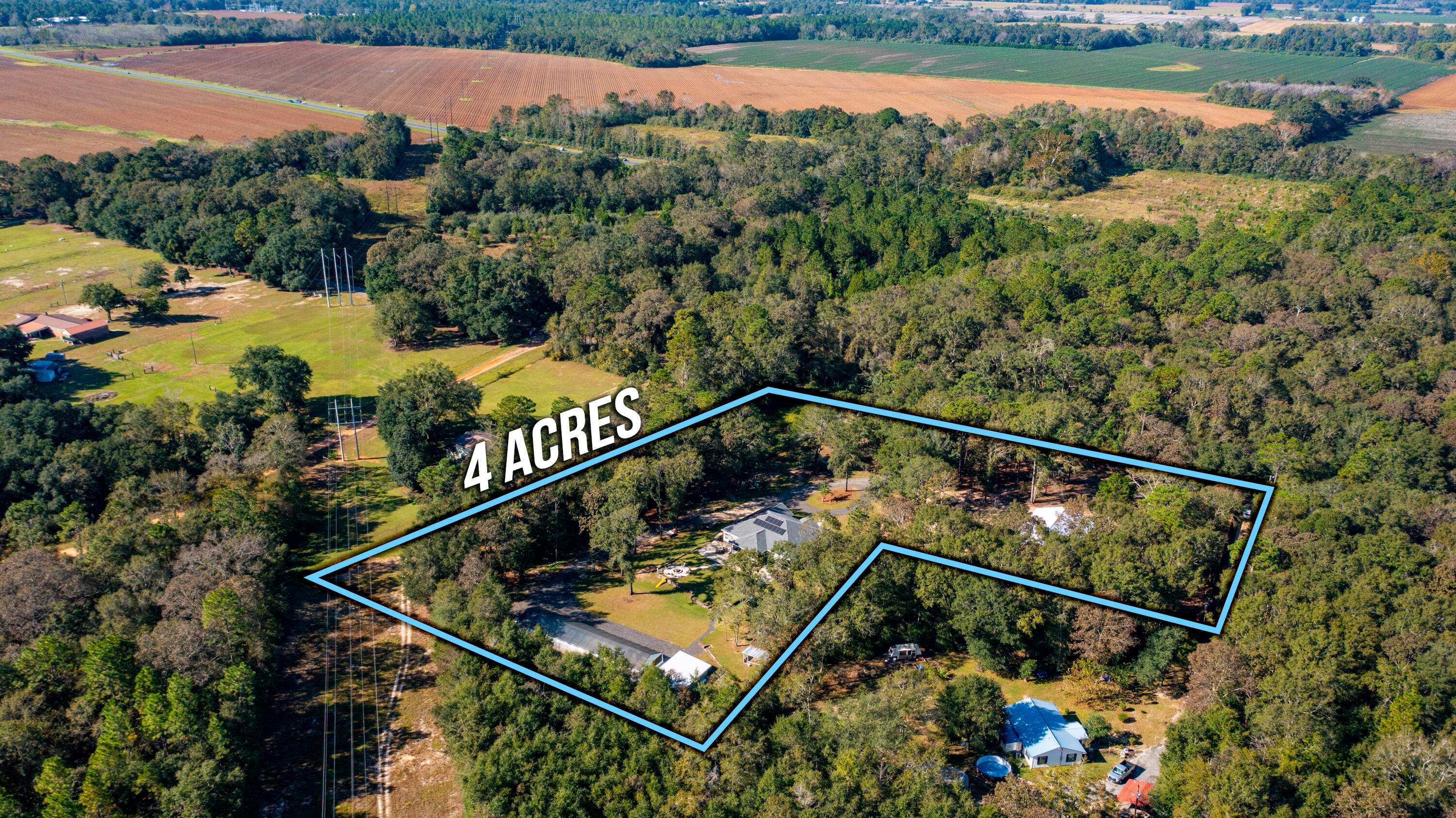 6053 Dairy Road Baker, FL 32531 - Photo 54 of 55 a view of a swimming pool with a lake and trees in the background