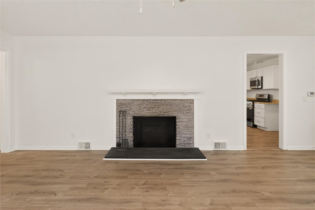 667 Hard Road Webster, NY 14580 - Photo 13 of 45 Wood Burning Fireplace in center of living room.