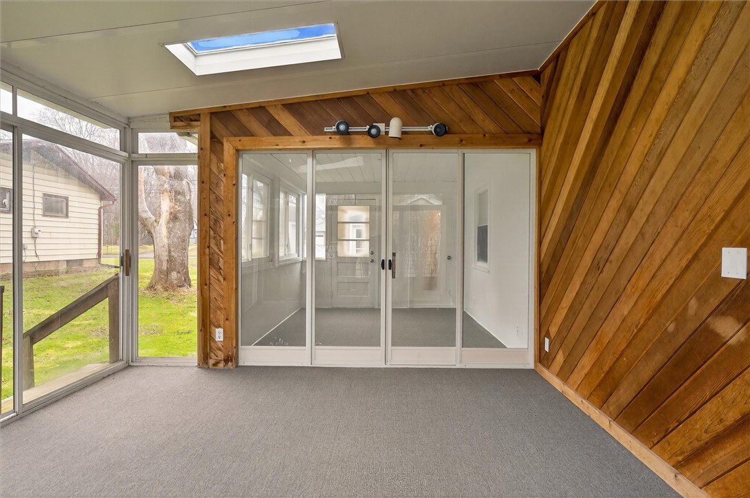 667 Hard Road Webster, NY 14580 - Photo 26 of 45 Two sky lights and steps to backyard. Enclosed por