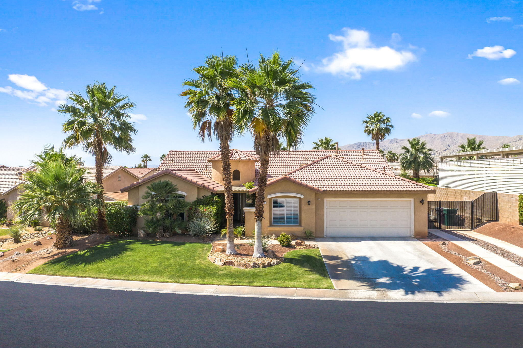 a front view of a house with a garden and yard